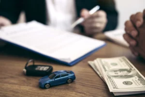 Signed car sale contract with keys and cash illustrating Chapter 13 bankruptcy car payment treatment.